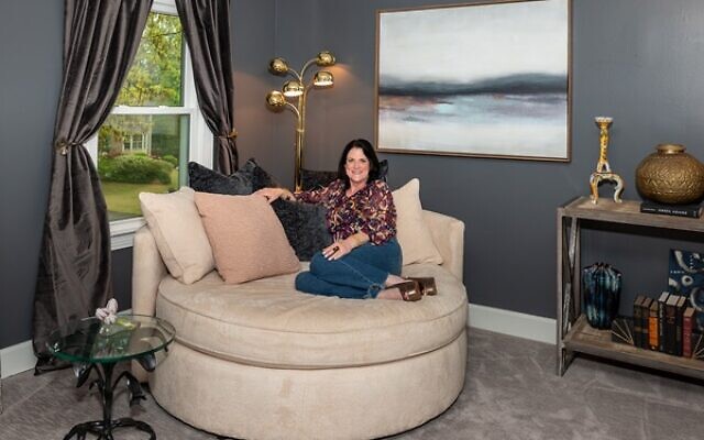 Candi Miller lounges in her primary bedroom suite on a Hollywood-era round sofa purchased at Mitchell Gold. In the background is Miller’s favorite restored 1950s brass lamp // All Photos by Howard Mendel