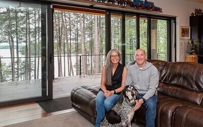 Amy and Steve Slotin relax with Blue Tick hound Opal, who is the star of their social media.  (Right) This Alaskan Inuit doll was found by the Slotins on their camping honeymoon.  // All Photos by Howard Mendel