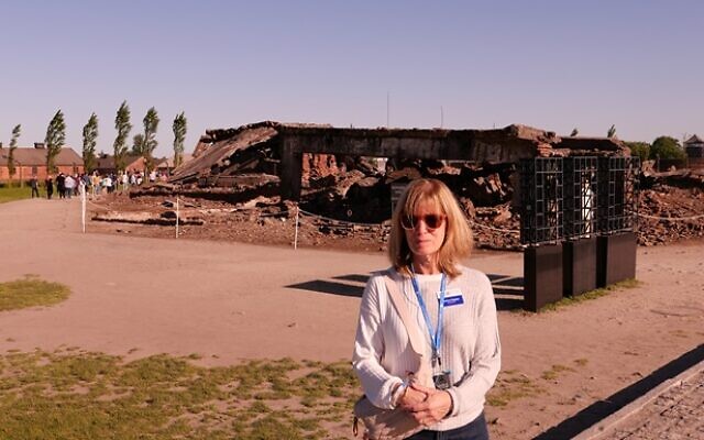 Barbara Kaplan is pictured in front of one of the five crematoriums located at Auschwitz-Birkenau.
