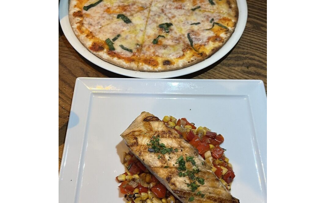 Margherita pizza (top) and the grilled salmon entree were hearty portions.