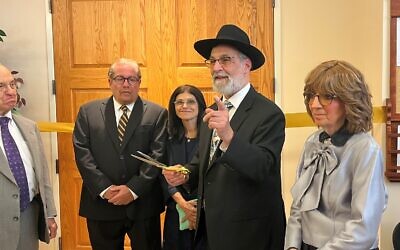 Murray Siegel (far left) and Lester and Linda Czupa look on as the Friedmans kvell over the rededication sign.   