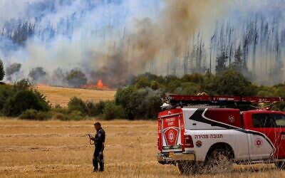 Firefighters try to extinguish a fire which broke out near Mesilat Zion, April 30, 2025 // Photo Credit: Noam Revkin Fenton/Flash90/Times of Israel