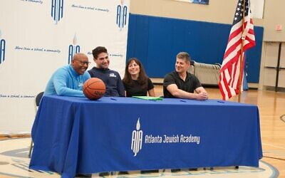 Atlanta Jewish Academy hosted a special ceremony to recognize senior basketball standout Zac Agichtein (second from left) who signed a letter of intent to play for Sarah Lawrence College.