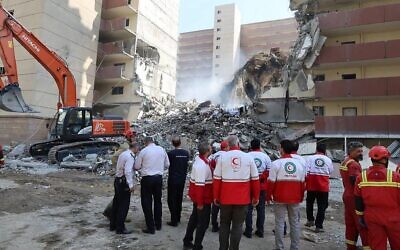 Iranian Red Crescent volunteers gathered in front of a building destroyed in an Israeli strike in Tehran, June 14, 2025 // Photo Credit: Iranian Red Crescent/AFP/Times of Israel