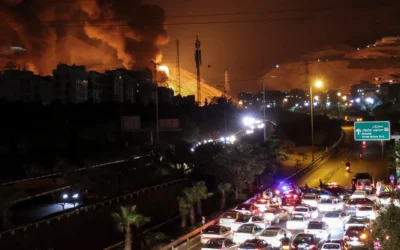 Vehicles jam a highway as a fire blazes nearby in the oil depots of Shahran, northwest of Tehran, on June 15, 2025 // Photo Credit: ATTA KENARE / AFP) / Times of Israel