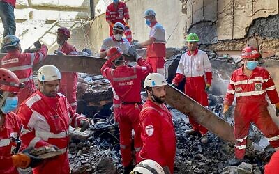 This handout picture released by the Iranian Red Crescent on June 17, 2025, shows members of rescue teams searching the debris inside a building in Tehran targeted by Israeli strikes // Photo Credit: Iranian Red Crescent/AFP/Times of Israel