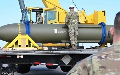 In this photo released by the US Air Force on May 2, 2023, airmen look at a GBU-57, or the Massive Ordnance Penetrator bomb, at Whiteman Air Base in Missouri // Photo Credit: US Air Force via AP, File/Times of Israel