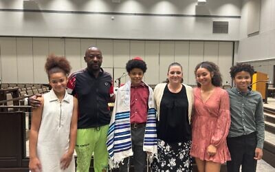 The Malobe family, taking a picture for their son, Isaac’s, bar mitzvah. (From left) Ariella, Abraham, Isaac, Jenifer, Isabella, and Abraham, Jr.