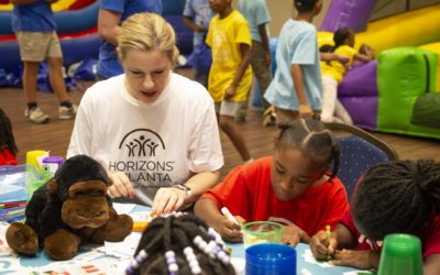 Horizons Atlanta’s Executive Director Ann Marie Bedtke participates with students in an activity that uses art to teach about zoology.