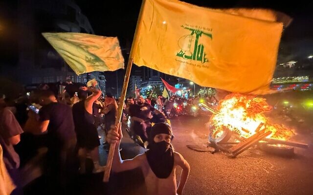 Supporters of Lebanon’s Hezbollah terror group block the streets with burning tires as they rally in cars and motorbikes to protest the government’s endorsement of a plan to disarm it, in Beirut’s southern suburbs, early on Aug. 8, 2025 // Photo Credit: Ibrahim AMRO/AFP/Times of Israel
