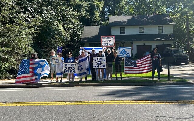 A group of protesters gather on Womack Road to sound off against Anna and Mark Bouzyk. A group of protesters gather on Womack Road to sound off against Anna and Mark Bouzyk.
