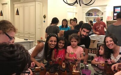 Delilah Cohen with her daughter Mia, Alon Schwartzberg with his daughter Noa, and Tanya Levin with her daughter Maya at the Joe Cohen packing in 2017.