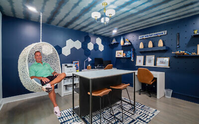 Craig Wolpert relaxes in the highly stylized study Keilin created using wallpaper by Innovations on the ceiling // All photos by Howard Mendel