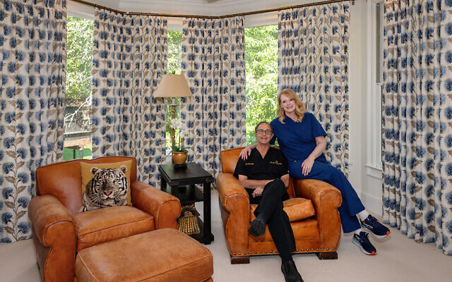 Georgia and Alan pose in their medical scrubs in the primary bedroom // All photos by Howard Mendel Georgia and Alan pose in their medical scrubs in the primary bedroom // All photos by Howard Mendel