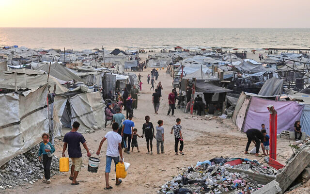 Displaced Palestinians walk through a makeshift camp along the beach in Gaza City, Aug. 10, 2025 // Photo Credit: AP Photo/Jehad Alshrafi/Times of Israel Displaced Palestinians walk through a makeshift camp along the beach in Gaza City, Aug. 10, 2025 // Photo Credit: AP Photo/Jehad Alshrafi/Times of Israel