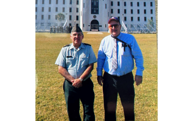 Stephen Silver (left) poses with a colleague in front of the historic Citadel in Charleston.