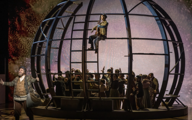 The Atlanta Opera’s “Fiddler On The Roof” at the Alliance Theatre is built around a dark and almost foreboding symbolic sphere of the world.