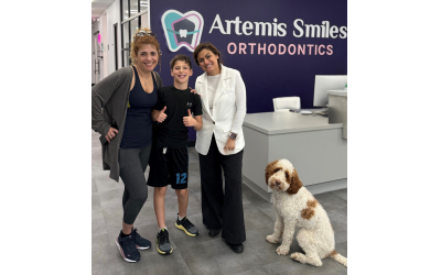 Tali and Daniel Ben-Senior (left) take a picture with Dr. Behnaz Yavari and the office dog, Tito, after Daniel gets his braces on.