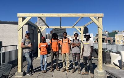 unCommon Construction staff and apprentices build a sukkah on the rooftop of the Museum of the Southern Jewish Experience //  Photo Credit: Museum of the Southern Jewish Experience