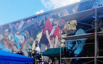 Artist Fabian Williams works on his large-scale mural of the 1906 race riot that was recently completed in south Atlanta.