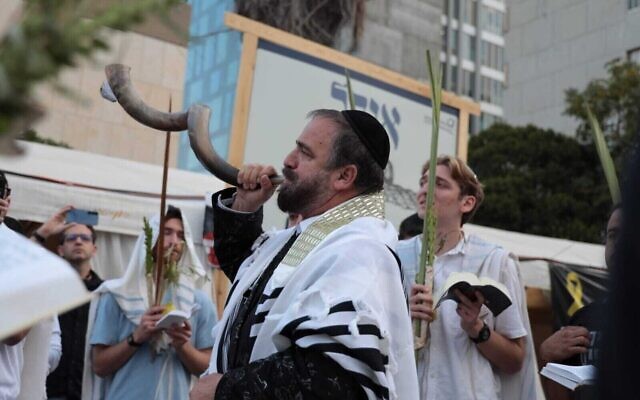Worshippers conduct a morning prayer service on the holiday of Hoshanna Rabba, the final day of the Sukkot festival, as they await the return of 20 living hostages at Hostages Square in Tel Aviv on Oct. 13, 2025 // Photo Credit: Lizzy Shaanan/Israeli Pro-Democracy Protest Movement/Times of Israel