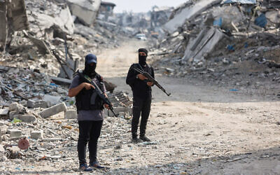 Hamas terrorists guard an area where they are searching for the bodies of hostages with the help of the International Committee of the Red Cross (ICRC) in Gaza City on Nov. 3, 2025 // Photo Credit: Omar Al-Qattaa/AFP