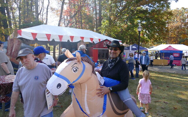 Lou Ladinsky, ever the team player, rides an inflatable horse as part of the AJT's "Boot, Scoot & BBQ" theme. Lou Ladinsky, ever the team player, rides an inflatable horse as part of the AJT's "Boot, Scoot & BBQ" theme.