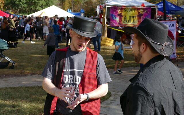 Bradley Ruby, dressed as a cowboy, is entertained by a card trick. Bradley Ruby, dressed as a cowboy, is entertained by a card trick.
