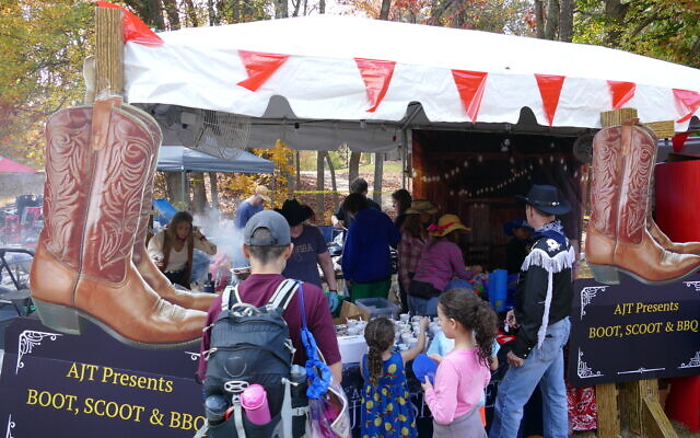 Festival attendees line up for samples from the AJT's "Boot, Scoot & BBQ" booth. Festival attendees line up for samples from the AJT's "Boot, Scoot & BBQ" booth.
