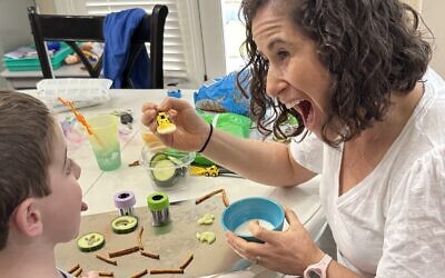 Carly Godzdanker of Mountain Kids OT makes feeding fun with ‘painting’ a child’s tongue with yogurt.