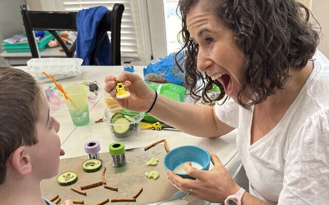 Carly Godzdanker of Mountain Kids OT makes feeding fun with ‘painting’ a child’s tongue with yogurt. Carly Godzdanker of Mountain Kids OT makes feeding fun with ‘painting’ a child’s tongue with yogurt.