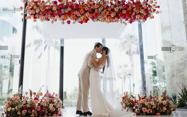 The bride and groom celebrate their first kiss as husband-and-wife. The bride and groom celebrate their first kiss as husband-and-wife.