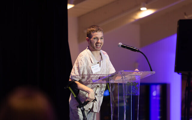 Adam Zborovsky, an athlete from the Israel ParaSport Center, takes the stage to speak about his journey of hope and resilience.