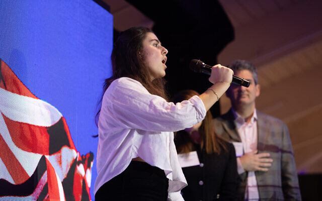 Weber High School student Einav Malka sings the national anthem.