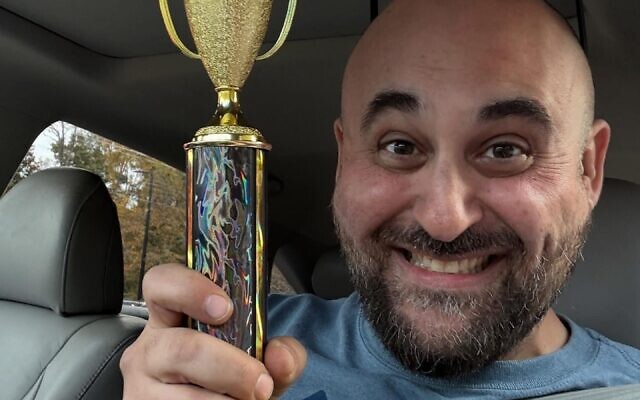 Michael Wolmer, of Noah's Bark, displays the team's trophy for first place in the Best Brisket category. Notably, Noah's Bark won the first ever perfect score in the brisket category // Photo Credit: Allen Wolmer Michael Wolmer, of Noah's Bark, displays the team's trophy for first place in the Best Brisket category. Notably, Noah's Bark won the first ever perfect score in the brisket category // Photo Credit: Allen Wolmer