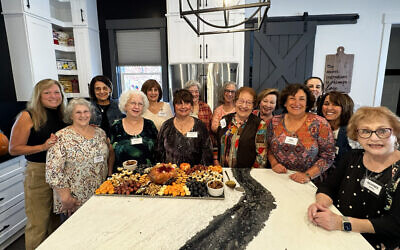 Hadassah members gather around the beautiful charcuterie board they helped create while learning about Hadassah’s Every Bite Counts program for healthy eating. 