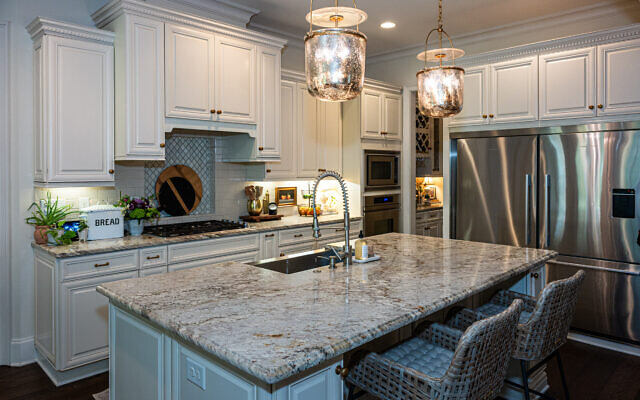 The kitchen has a pullout spice rack, a gigantic refrigerator, and vintage wood boards to make it fun and functional.   