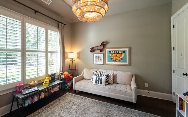 The kids’ playroom is centered by a poster from Jaffa, Israel, with a view to the outdoors. Liz recommends dark rugs for play areas. 