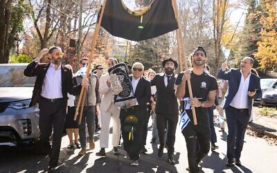 Robert Feldberg, alongside Rabbi Yisrael New, had a turn in carrying the Torah in the processions.