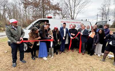 The Lubin family, Howard Zavell, Richard Zelin, Royi Ende, and others cut the ribbon for the Magen David Adom ambulance dedicated to Rose Lubin. 