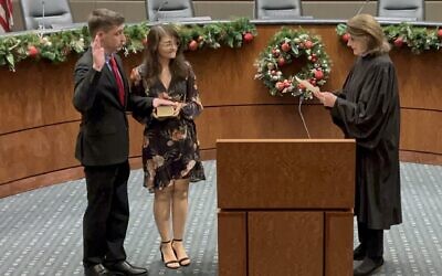 Jason Goldstein is sworn in to his third term on the Marietta City Council. Pictured next to him is his fiancé, Kimberly Caras, and swearing in Goldstein is Senior Superior Court Judge Adele Grubbs  // Photo courtesy of Philip Goldstein