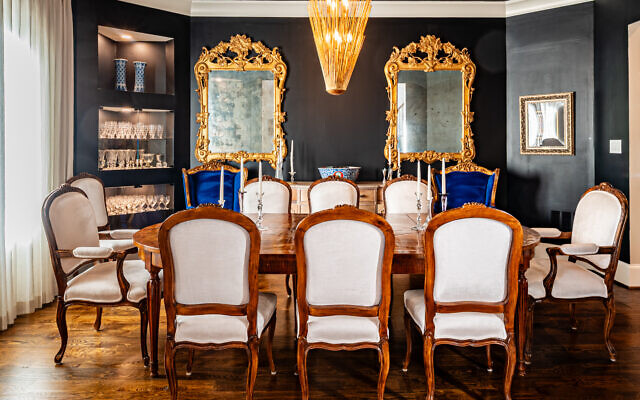 The dining room paint color is Tricorn Black which gives off blue vibes. An Imari bowl is in the background. The mirrors are Italian antiques. 