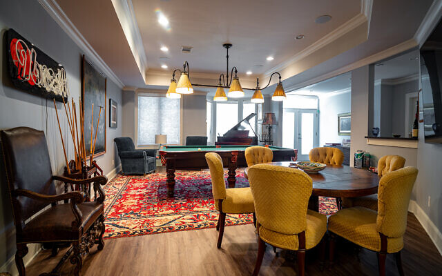 The lower level features an antique foosball table and a special light over the pool table that Mike designed. The 96 Rock neon was from Cheryl’s long career there.