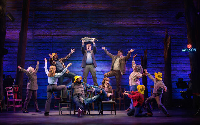 Some cast members in “Come From Away” played more than one part. Lowery Brown (standing in brown jacket and yellow shirt) also portrayed the rabbi. Some cast members in “Come From Away” played more than one part. Lowery Brown (standing in brown jacket and yellow shirt) also portrayed the rabbi.