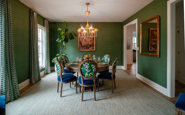 The Belenky dining room has bright green grass cloth wallpaper by Thibaut. The painting is by Amy Dixon.  