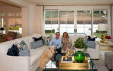 Sally and Erik, both attorneys by training, pose with Scout, their seven-year-old English cream golden retriever in their living room. The home was completely renovated in 2022 // Photos by Howard Mendel  