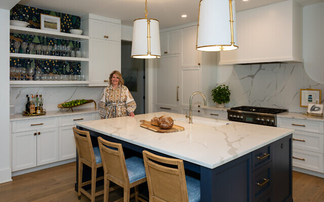 A New Orleans native, Sally makes a spicy jambalaya, among other Louisiana favorites. The counters are quartz with (above) coated aluminum pendants with antique brass finish by Carrier and Company.  