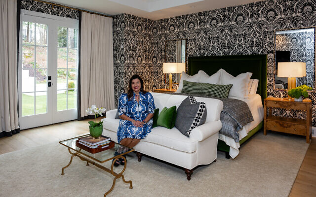 Nectar & Nest Interiors founder and principal designer, Kattia Easterly, went for the drama in the primary bedroom, using cream and black with bold wallpaper. The green velvet upholstered bed is a nature-loving contrast.     