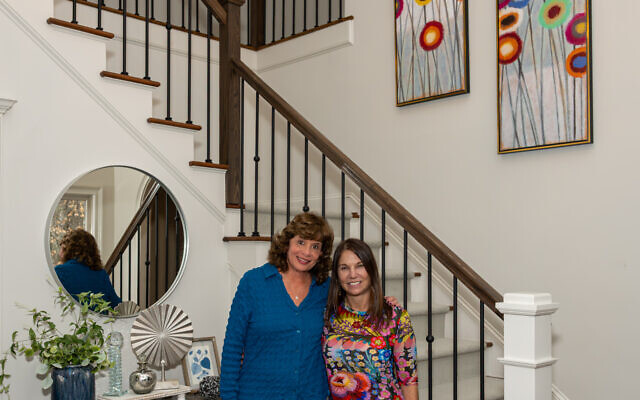 Sheryl and Jill (right) pose in the entrance and plan the next stage of bedroom design.