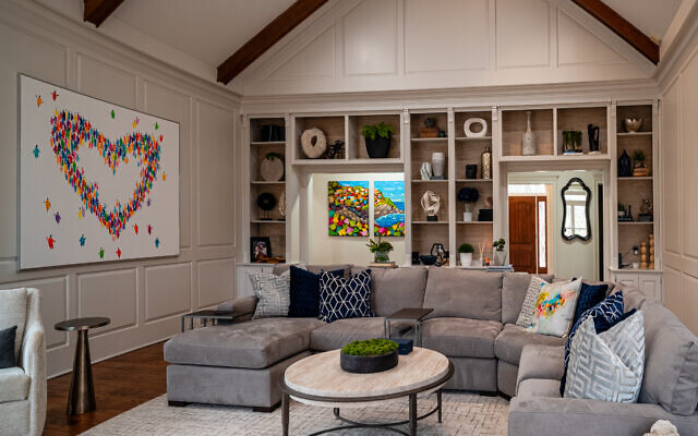 The Eisenberg great room is a happy place because of this heart composition that Sheryl fell in love with. A tryptic of Cinque Terra, Italy, peeps through the room’s entrance. 